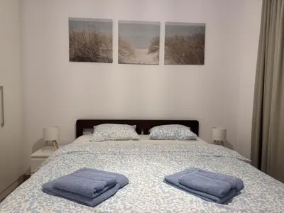 a bedroom with a bed with two towels on it at Beograd na vodi Belgrade waterfront - 23th floor, great view apartment in Belgrade