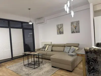 a living room with a couch and a table at Beograd na vodi Belgrade waterfront - 23th floor, great view apartment in Belgrade