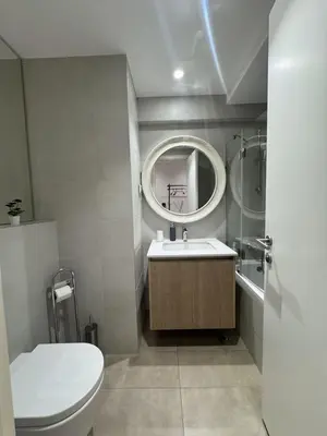 a bathroom with a toilet and a sink and a mirror at Beograd na vodi Belgrade waterfront - 23th floor, great view apartment in Belgrade
