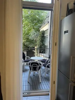 an open door to a patio with a table and chairs at Central Apartment Toplica in Belgrade