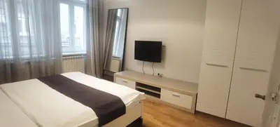 a bedroom with a bed and a tv on the wall at Central Apartment Toplica in Belgrade