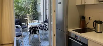 a kitchen with a balcony with a table and chairs at Central Apartment Toplica in Belgrade