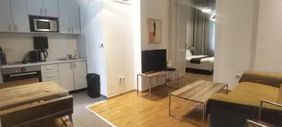 a living room with a couch and a table in a room at Central Apartment Toplica in Belgrade