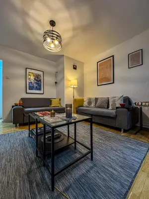 a living room with a couch and a table at Vista Dorćol - Old Town - Heart of Belgrade in Belgrade