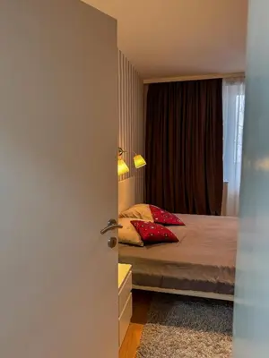 a bedroom with a bed with red pillows at Vista Dorćol - Old Town - Heart of Belgrade in Belgrade