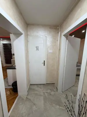 a room with a white door with a drawing on it at Centar Lux Obrenovac, Na Trgu, Siguran Parking in Obrenovac