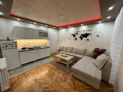 a living room with a couch and a kitchen at Centar Lux Obrenovac, Na Trgu, Siguran Parking in Obrenovac