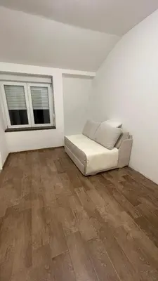 a white room with a couch and two windows at Vranjes apartman in Beograd
