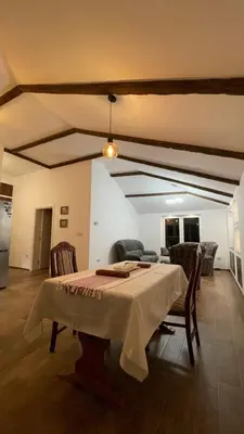 a dining room with a table and some chairs at Vranjes apartman in Beograd