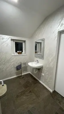 a white bathroom with a sink and a mirror at Vranjes apartman in Beograd