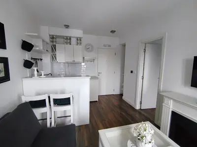 a living room with a couch and a table and a kitchen at Benvenuti SUN in Belgrade