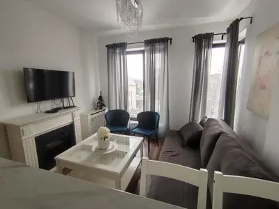 a living room with a couch and a table at Benvenuti SUN in Belgrade