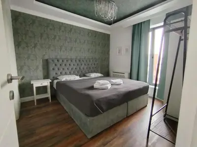 a bedroom with a bed with two towels on it at Benvenuti SUN in Belgrade