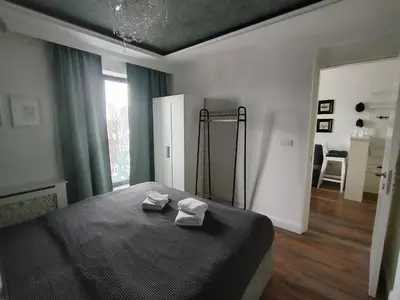 a bedroom with a bed with two towels on it at Benvenuti SUN in Belgrade