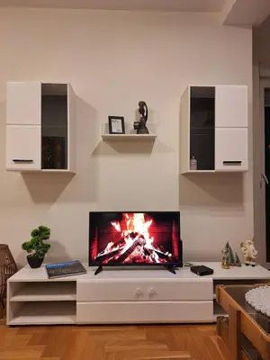 a living room with a large tv on a wall at Nika Apartments Vracar in Belgrade