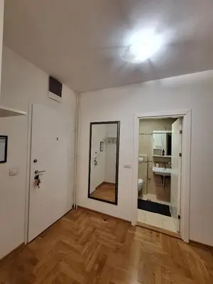 an empty room with a mirror and a bathroom at Nika Apartments Vracar in Belgrade