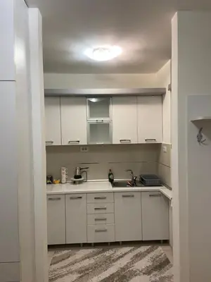 a kitchen with white cabinets and a sink at Nika Apartments Vracar in Belgrade