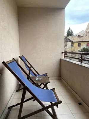 a blue rocking chair sitting on a balcony at Nika Apartments Vracar in Belgrade