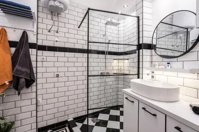 a white bathroom with a sink and a mirror at City Center Suites, Two Connected Apartments, 10 Guests in Belgrade