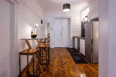 a kitchen with a counter and a refrigerator at City Center Suites, Two Connected Apartments, 10 Guests in Belgrade