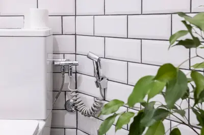 a shower in a bathroom with white tiles at City Center Suites, Two Connected Apartments, 10 Guests in Belgrade