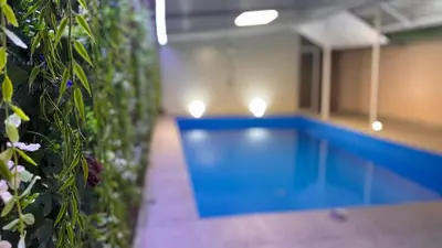 a swimming pool in a building with lights on it at Barrique apartments sa zatvorenim bazenom in Smederevo