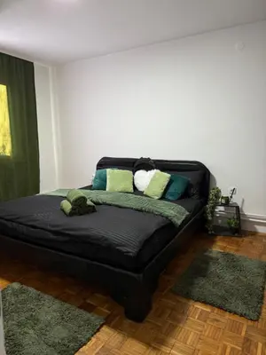 a black bed in a room with pillows on it at Barrique apartments sa zatvorenim bazenom in Smederevo