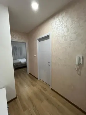 an empty room with a door and a bedroom at Gold Star Apartman in Ruma