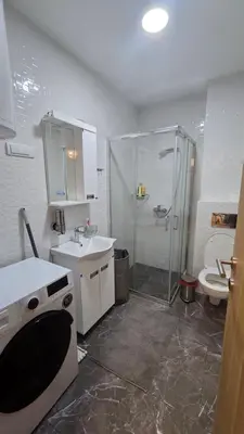 a bathroom with a shower and a sink and a toilet at Apartman Simić in Smederevo