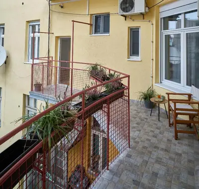 a balcony with plants on a building at Take One in Belgrade