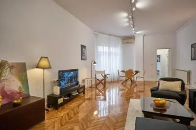 a living room with a couch and a tv at Take One in Belgrade