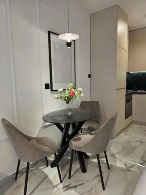a dining room table with chairs and a vase of flowers at Sotto Il Sole in Surčin