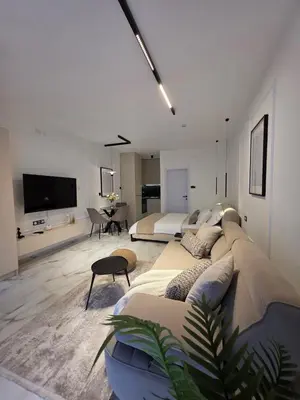 a living room with a large couch and a bedroom at Sotto Il Sole in Surčin