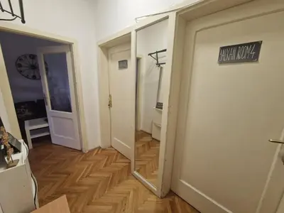 a hallway with a mirror and a door with a sign on it at Urban Stay Balkanska in Belgrade