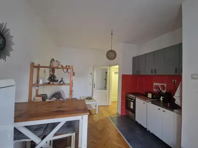 a kitchen with white cabinets and red tiles at Urban Stay Balkanska in Belgrade