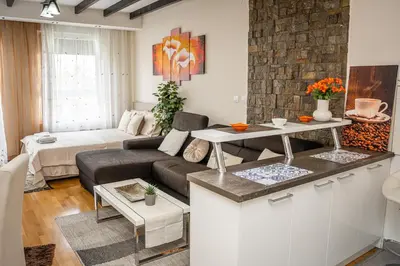 a living room with a couch and a table at Osmica New Belgrade in Bežanija