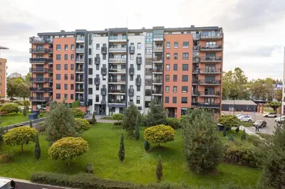 an apartment building with a park in front of it at Osmica New Belgrade in Bežanija