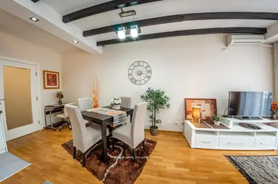 a dining room with a table and a desk at Osmica New Belgrade in Bežanija