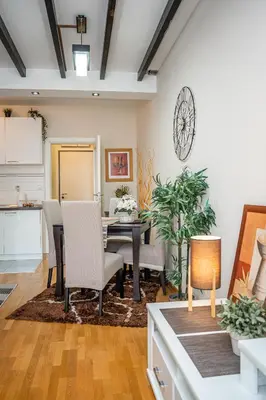 a kitchen and dining room with a table and chairs at Osmica New Belgrade in Bežanija