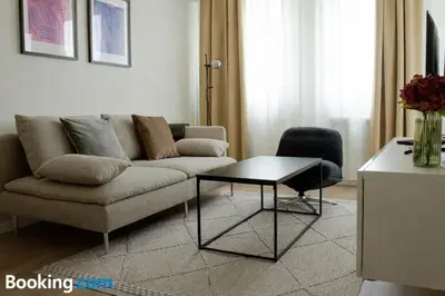 a living room with a couch and a table at Aura Apartment - with Garage Parking in Belgrade