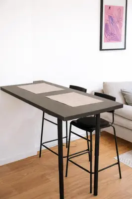 a black table and two chairs in a living room at Aura Apartment - with Garage Parking in Belgrade
