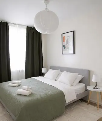 a bedroom with a large bed with two towels on it at Aura Apartment - with Garage Parking in Belgrade