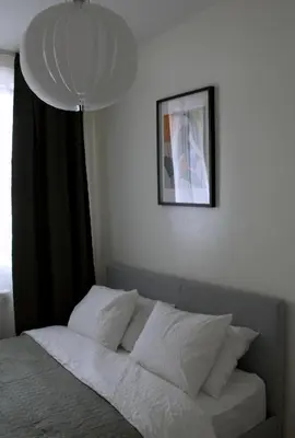 a bed in a bedroom with a picture on the wall at Aura Apartment - with Garage Parking in Belgrade