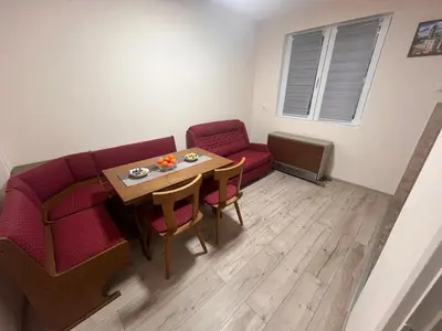 a living room with a couch and a table and chairs at Apartman Tas in Smederevo