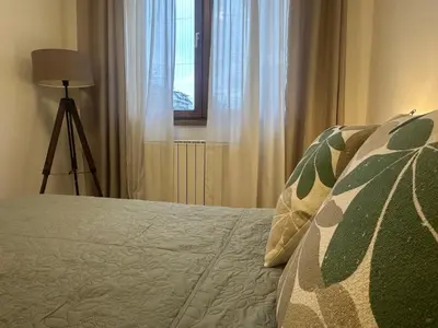 a bedroom with a bed and a window at Garden Escape Zemun in Belgrade