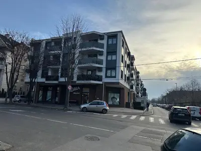 a building on a city street with cars parked at Garden Escape Zemun in Belgrade