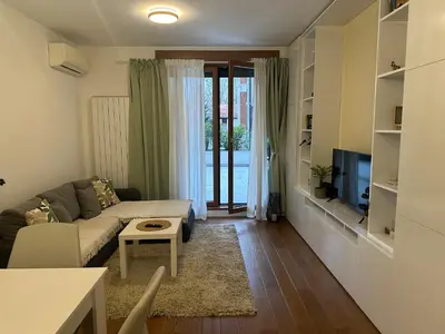 a living room with a couch and a tv at Garden Escape Zemun in Belgrade