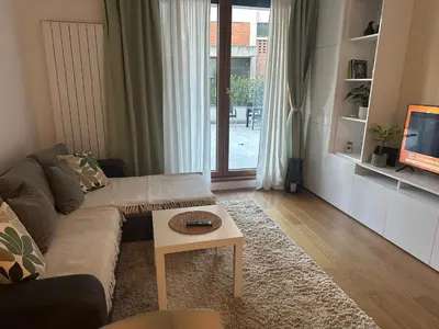a living room with a couch and a table at Garden Escape Zemun in Belgrade