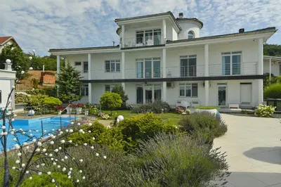 a large white house with a swimming pool at Apartments Villa Graf in Smederevo
