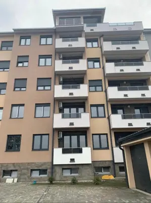 a tall apartment building with many windows at Royal Residence aprtamani Aviv in Pančevo